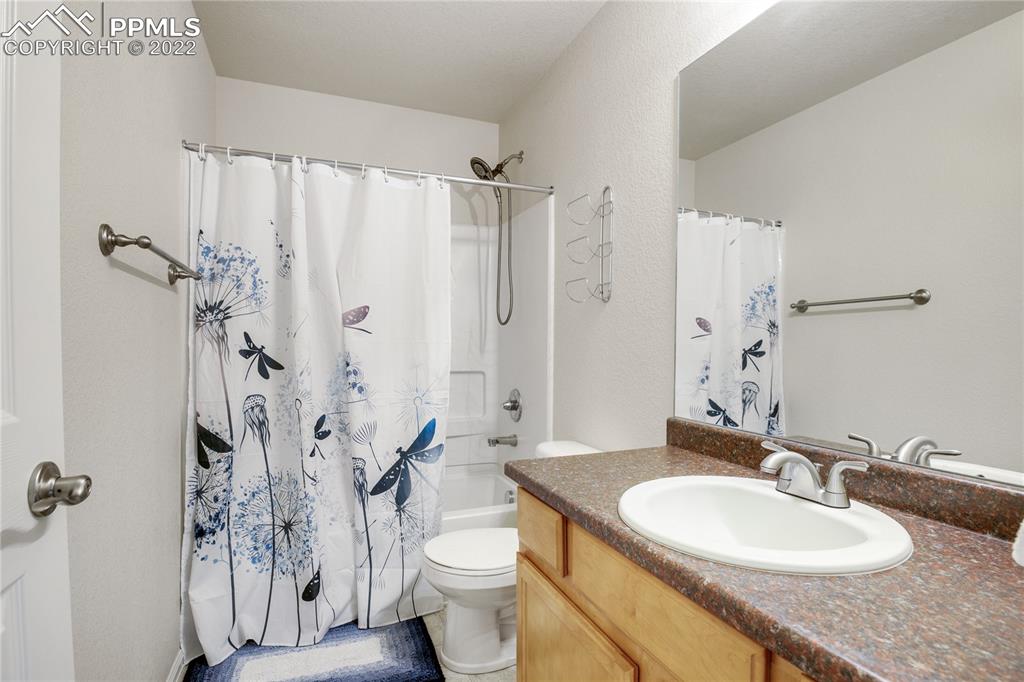 6446 Dancing Moon Way Colorado Springs, CO 80911 - Photo 24 of 42 a bathroom with a granite countertop sink toilet and shower