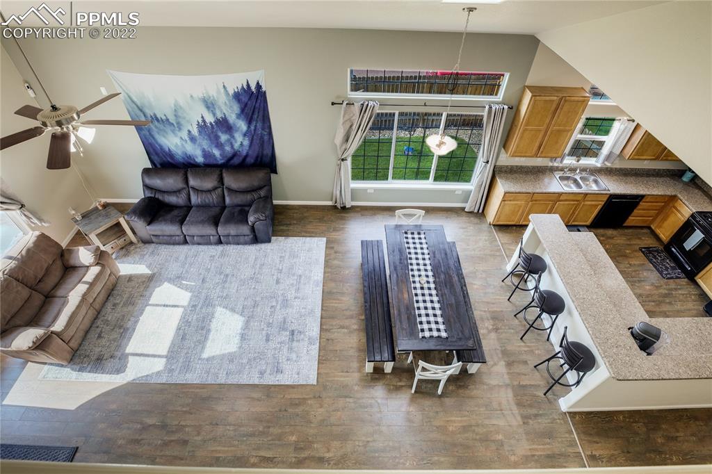 6446 Dancing Moon Way Colorado Springs, CO 80911 - Photo 25 of 42 a living room with furniture and floor to ceiling window