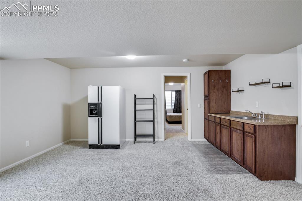 6446 Dancing Moon Way Colorado Springs, CO 80911 - Photo 27 of 42 a kitchen with stainless steel appliances granite countertop a refrigerator and stove