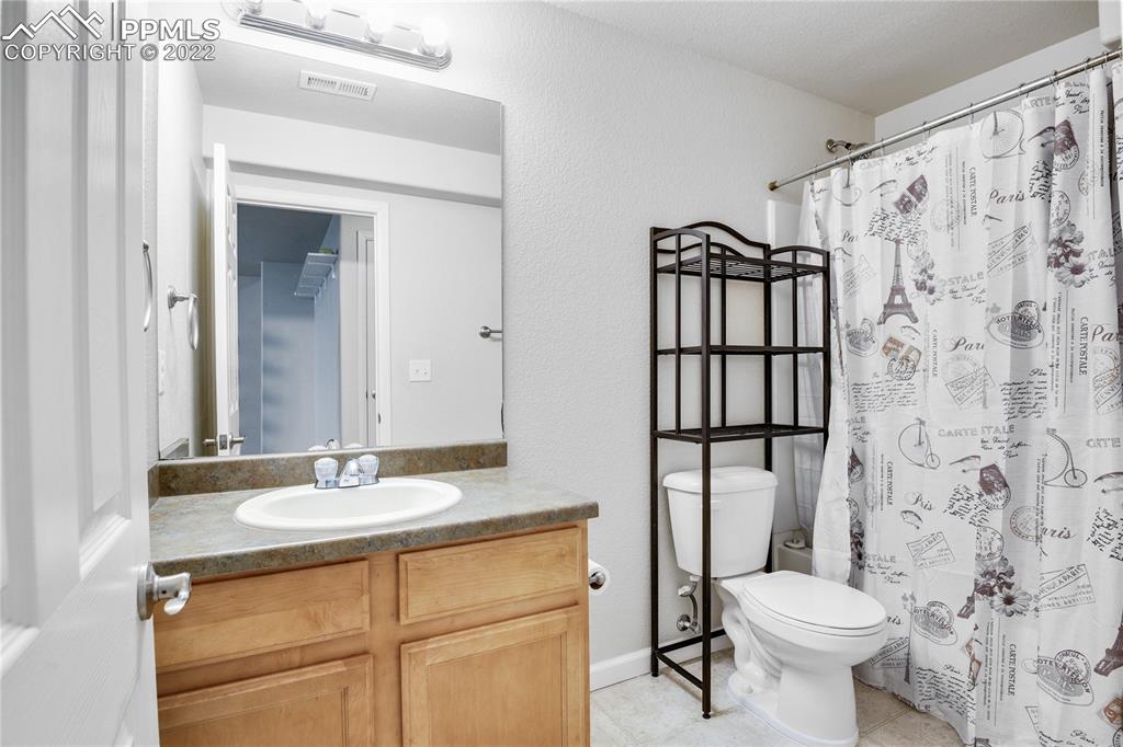 6446 Dancing Moon Way Colorado Springs, CO 80911 - Photo 30 of 42 a bathroom with a sink toilet and shower
