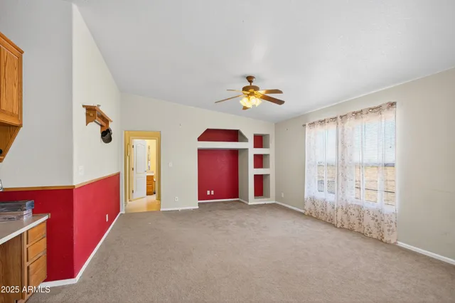 a view of an empty room with a fan
