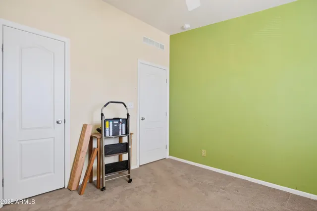 a utility room with stainless steel appliances wooden floor and windows