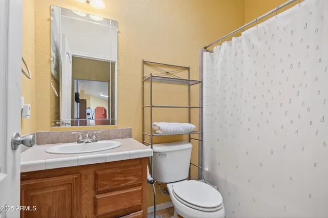 an empty room with closet and a chandelier fan