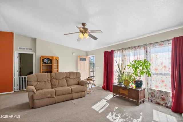 a kitchen with a stove a sink a dining table and chairs