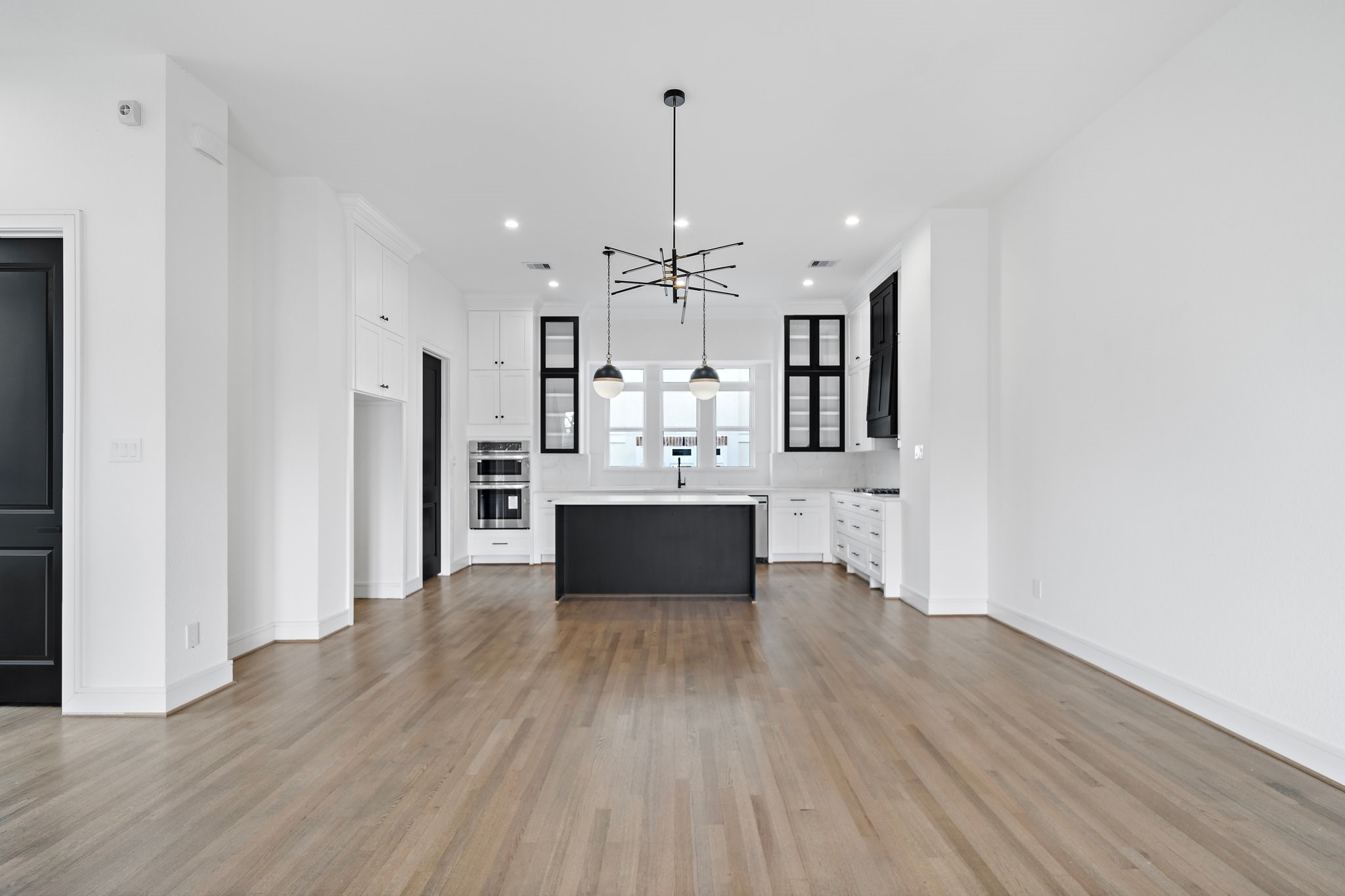 1005 East 28th Street Houston, TX 77009 - Photo 13 of 35 a view of a kitchen with wooden floor and electronic appliances