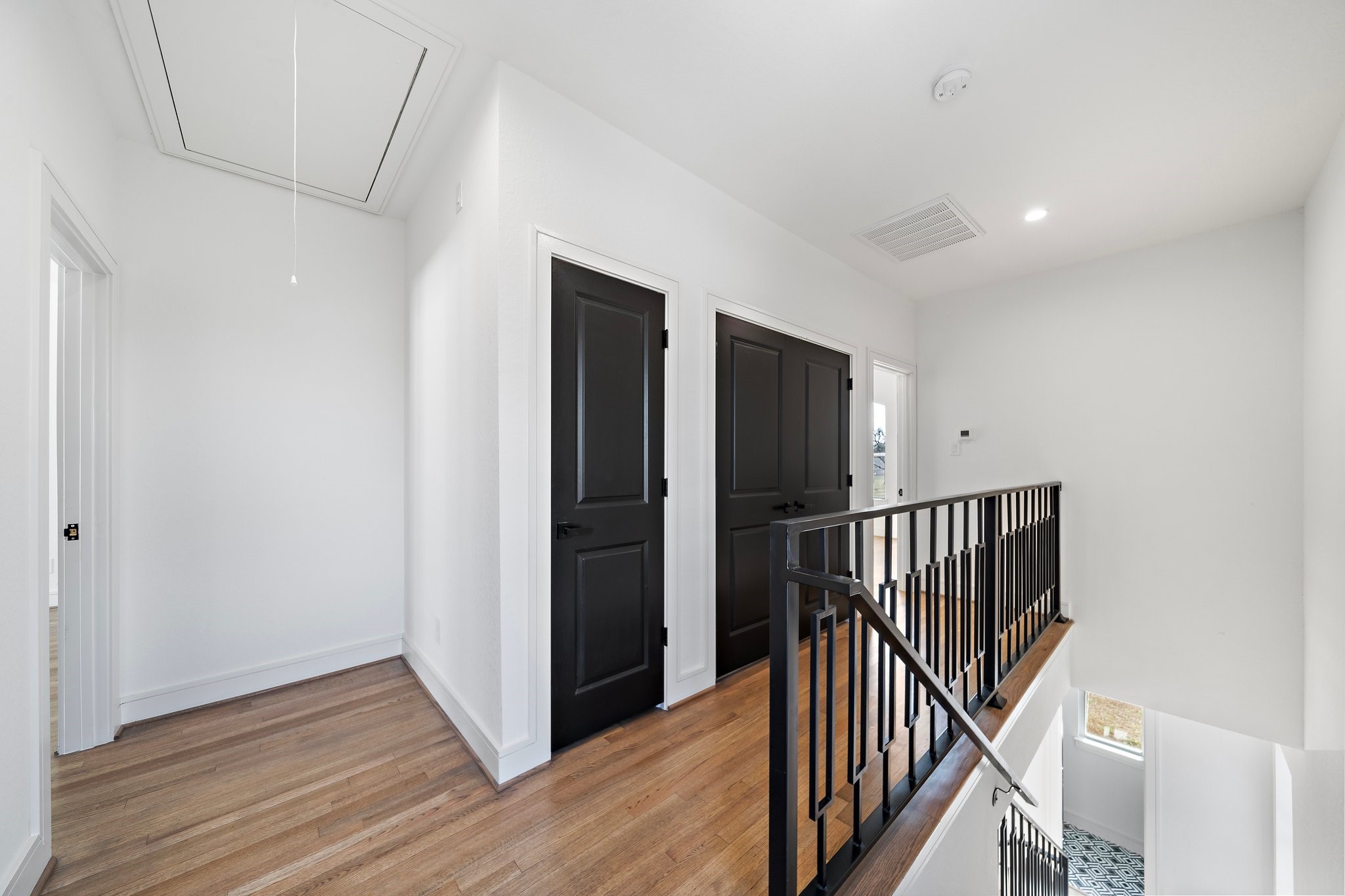 1005 East 28th Street Houston, TX 77009 - Photo 18 of 35 a view of a hallway with wooden floor and stairs