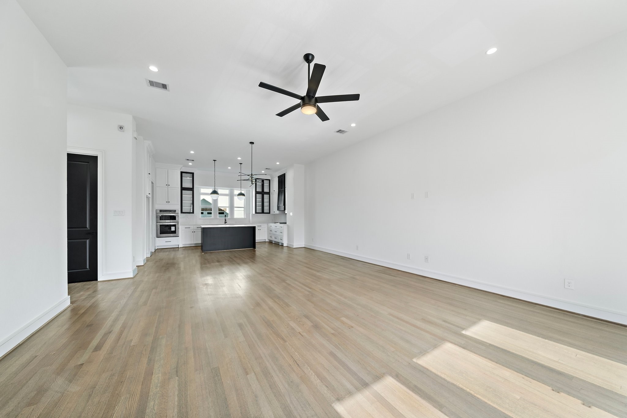 1005 East 28th Street Houston, TX 77009 - Photo 29 of 35 a view of a kitchen with a sink and dishwasher a refrigerator with wooden floor
