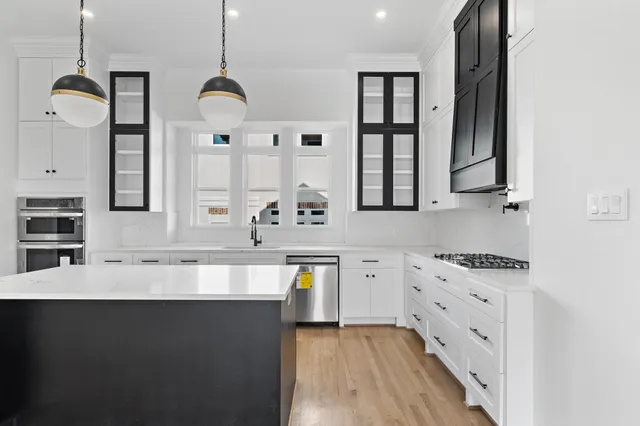 a large kitchen with granite countertop a sink a stove and dishwasher