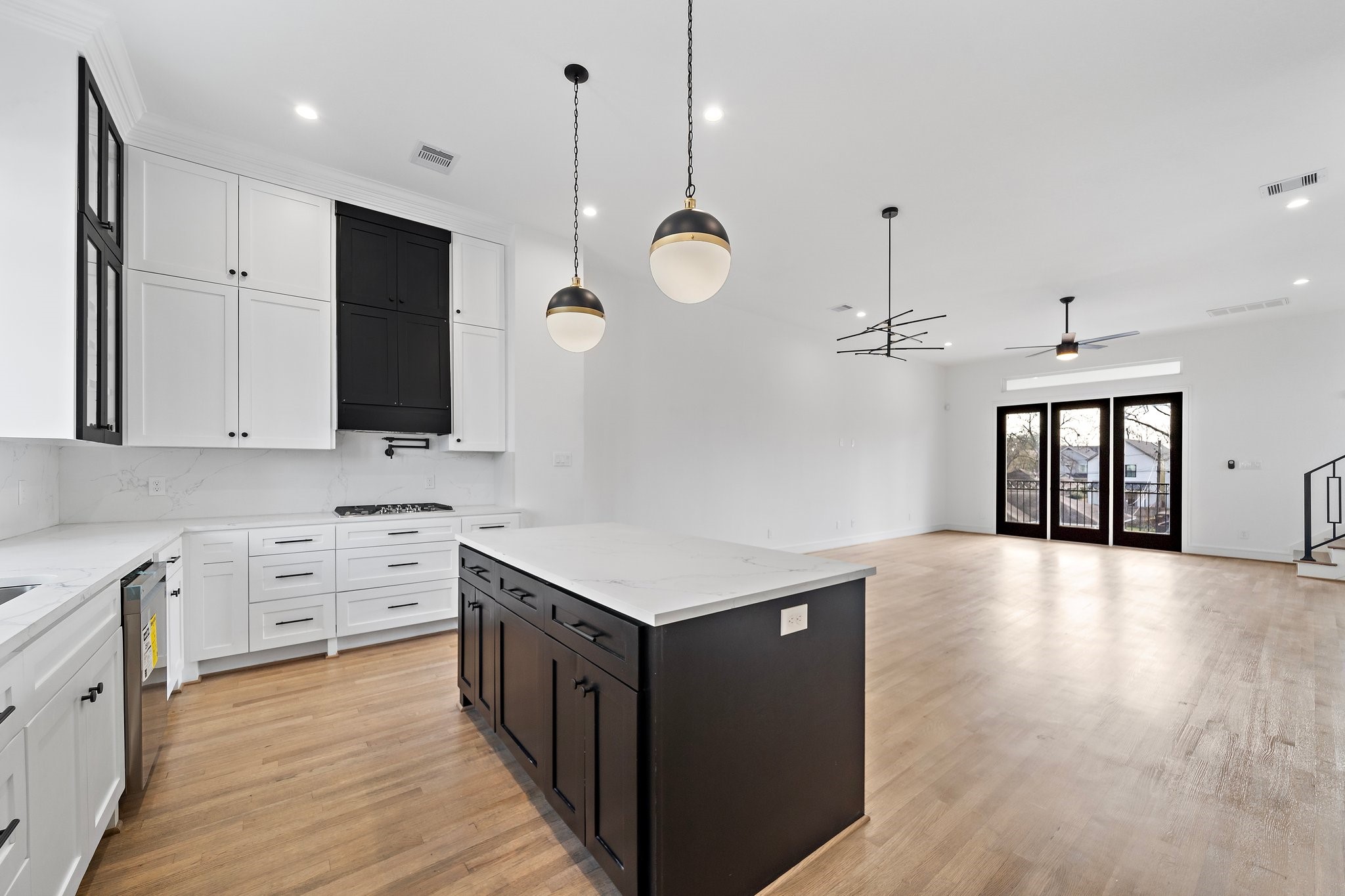 1005 East 28th Street Houston, TX 77009 - Photo 6 of 35 a kitchen with granite countertop a sink dishwasher a stove and a wooden floors