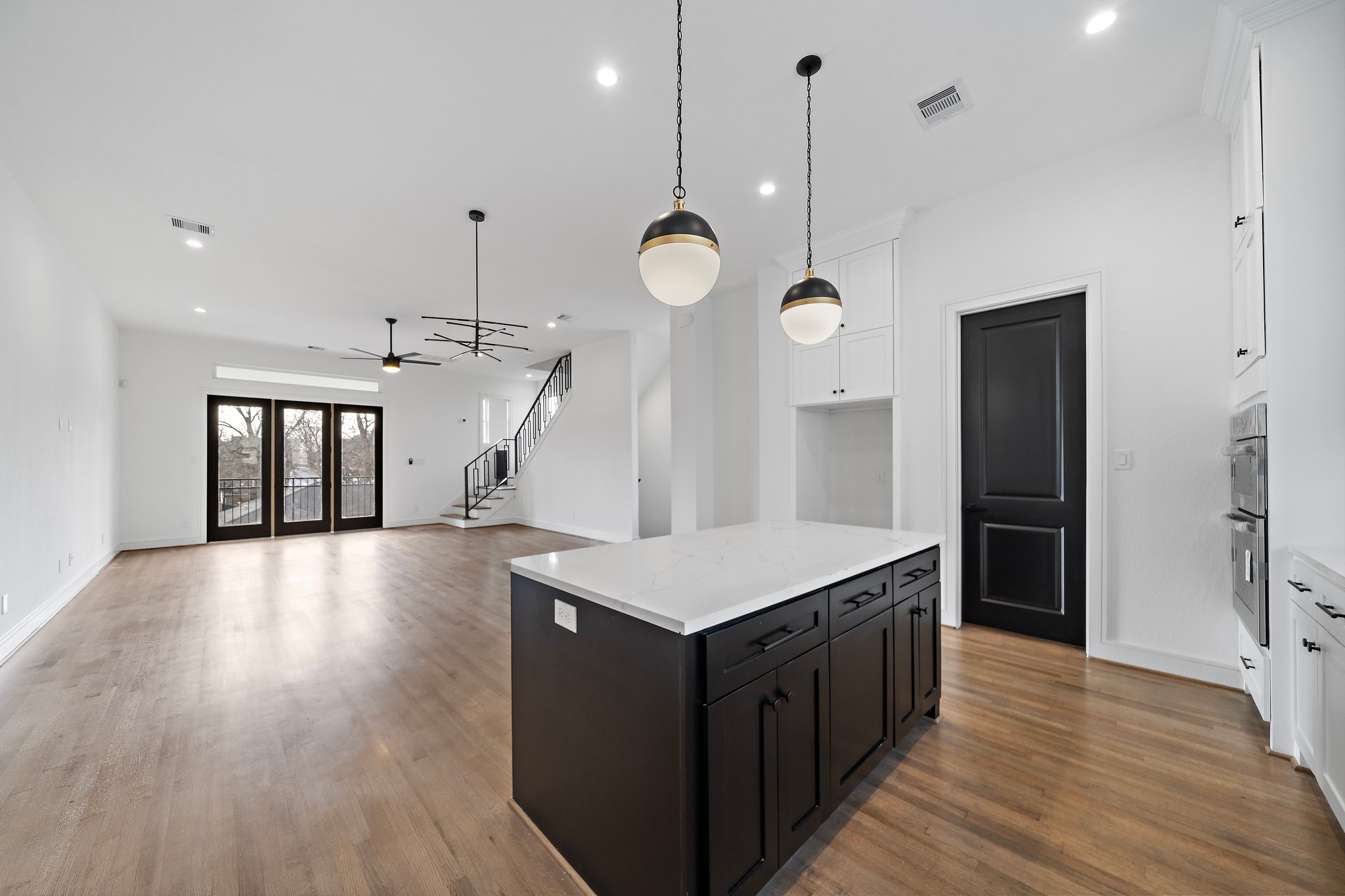 1005 East 28th Street Houston, TX 77009 - Photo 8 of 35 a kitchen that has a lot of cabinets and wooden floor