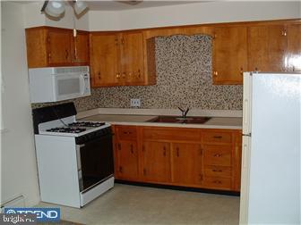 121-123 West Washington Street Riverside, NJ 08075 - Photo 4 of 6 a kitchen with stainless steel appliances granite countertop a stove a sink and a microwave