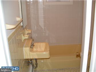 121-123 West Washington Street Riverside, NJ 08075 - Photo 6 of 6 a bathroom with a sink and a mirror