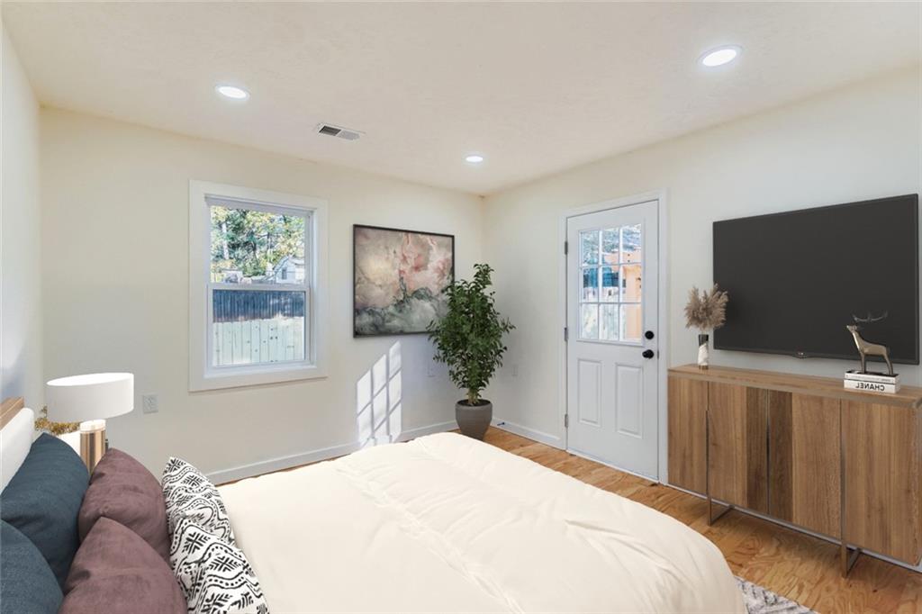 194 Dearborn Street Southeast Atlanta, GA 30317 - Photo 15 of 25 a bedroom with a bed and a flat screen tv