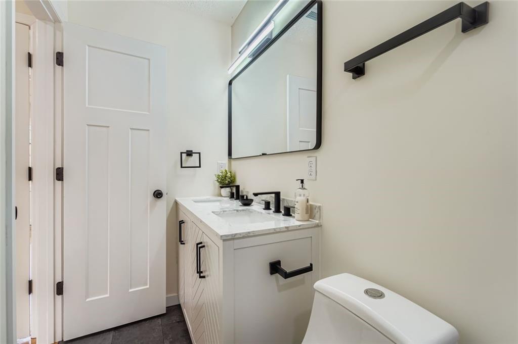 194 Dearborn Street Southeast Atlanta, GA 30317 - Photo 17 of 25 a bathroom with a sink toilet and mirror