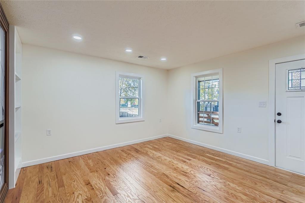 194 Dearborn Street Southeast Atlanta, GA 30317 - Photo 6 of 25 a view of empty room with wooden floor and fan