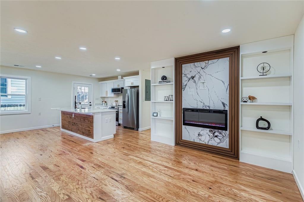 194 Dearborn Street Southeast Atlanta, GA 30317 - Photo 9 of 25 a large white kitchen with stainless steel appliances granite countertop a refrigerator and a stove