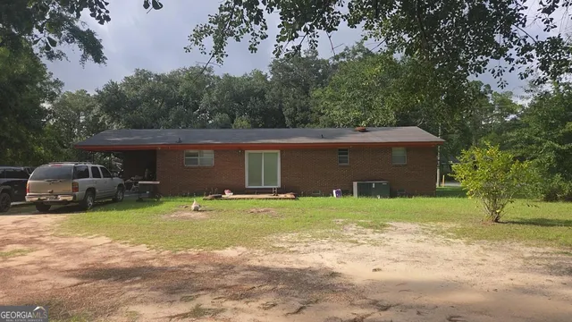 a front view of a house with a garden