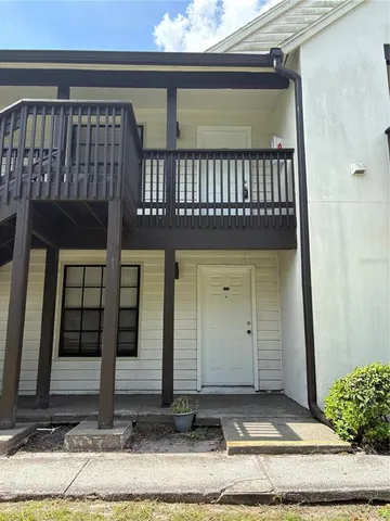a view of a house with a door and wooden floor