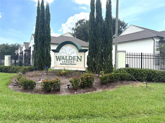 a view of a house with a small yard and plants