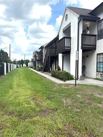 a view of a house with a flower garden