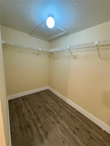 an empty room with a ceiling fan and a window