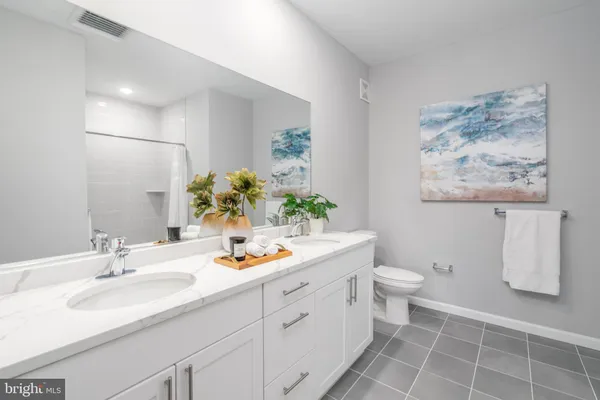 a bathroom with a sink toilet and a mirror