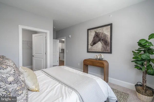 a bedroom with a bed and a potted plant