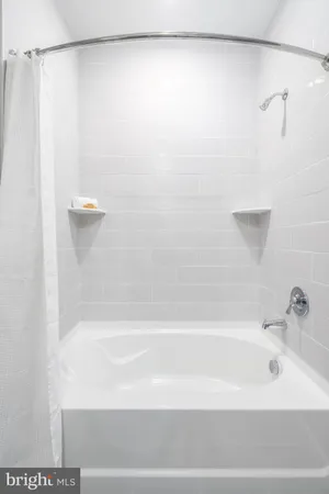 a bathroom with a shower and a bath tub