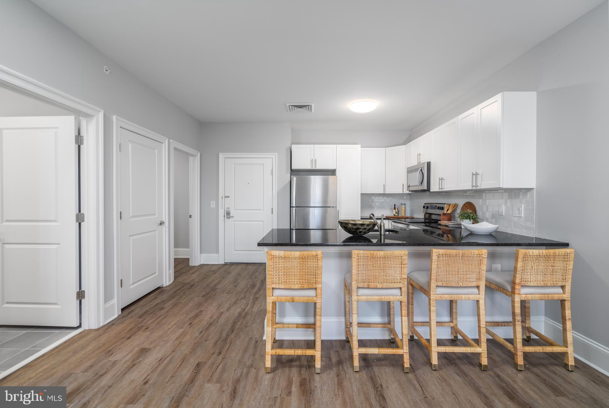 700 Citation Lane, Unit 1249 Cherry Hill, NJ 08002 - Photo 4 of 33 a kitchen with wooden floors and wooden cabinets