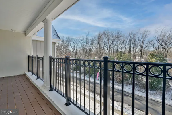 a view of a balcony with wooden fence