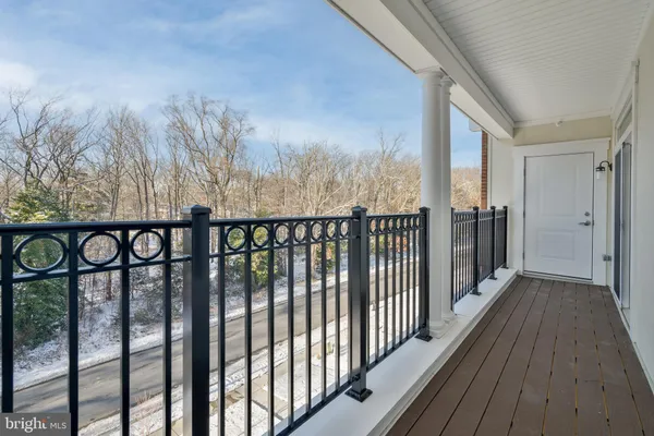 a view of a balcony with wooden floor