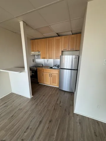 a kitchen with wooden floors and wooden cabinets