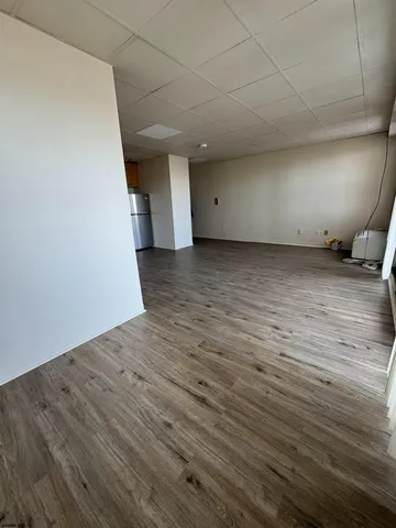 a view of a room with wooden floor