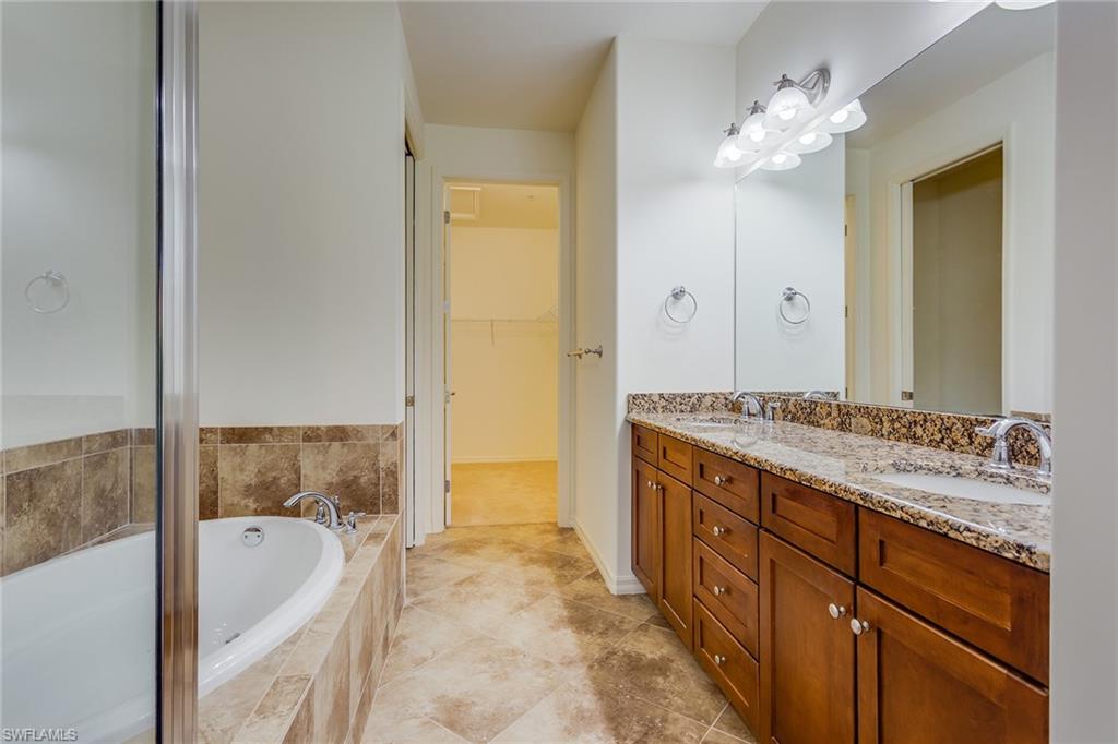 9037 Alturas Street, Unit 372 Naples, FL 34113 - Photo 12 of 23 a spacious bathroom with a tub sink and mirror