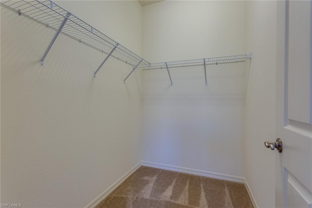 9037 Alturas Street, Unit 372 Naples, FL 34113 - Photo 14 of 23 a view of a room with racks on the wall