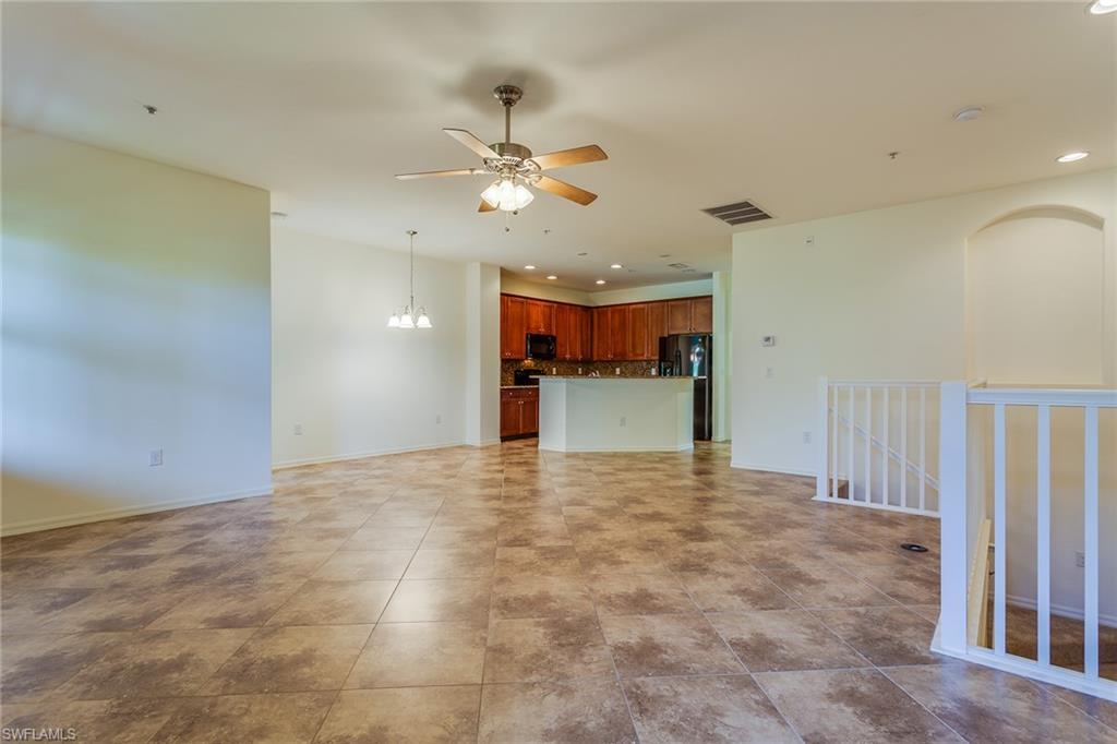 9037 Alturas Street, Unit 372 Naples, FL 34113 - Photo 6 of 23 a view of a kitchen with a sink and refrigerator