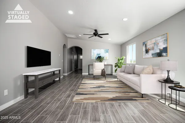 a view of a livingroom with furniture wooden floor and a window