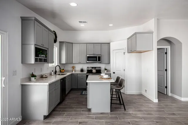 a kitchen with stove and refrigerator