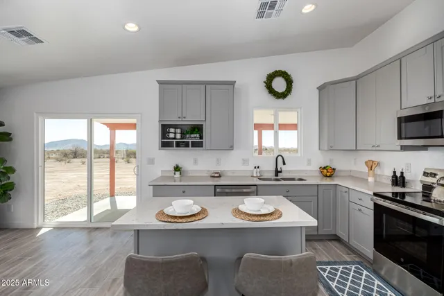 a view of a kitchen with a sink and wooden floor