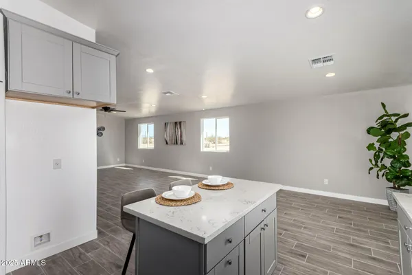 a view of a kitchen with a sink and wooden floor