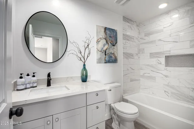 a bathroom with a bathtub and shower