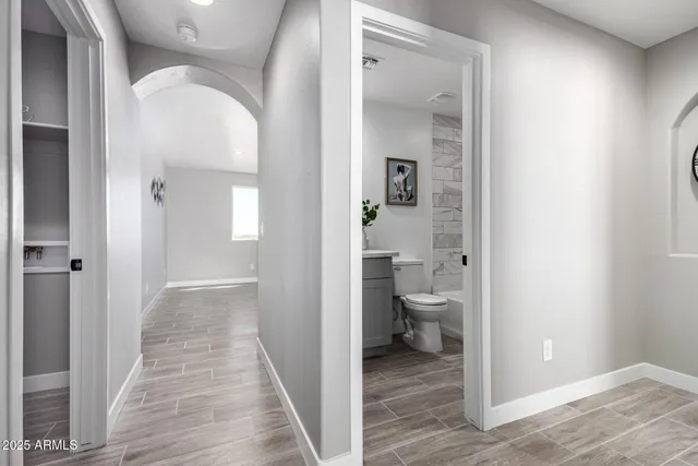 a view of room with hardwood floor and a ceiling fan