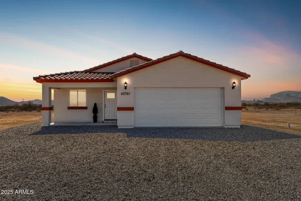 a house that has a small yard and a large parking space