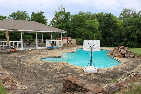 a backyard of a house with table and chairs