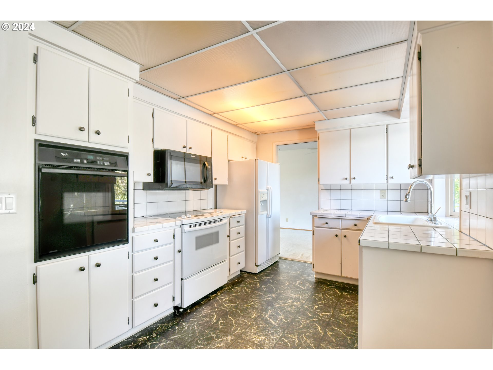 3239 Southwest Isaac Avenue Pendleton, OR 97801 - Photo 11 of 42 a kitchen with granite countertop white cabinets a oven a sink and dishwasher
