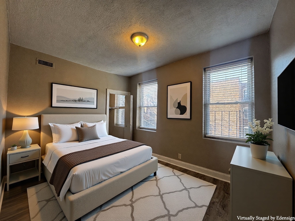 1870 Beacon Street, Unit 54 Brookline, MA 02445 - Photo 5 of 13 a bedroom with a bed and a potted plant