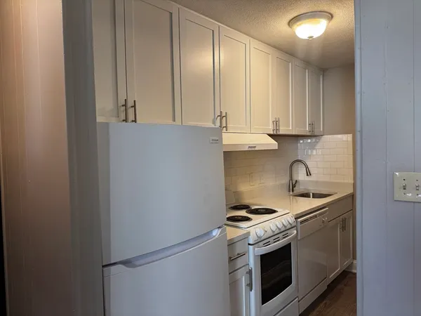 a kitchen with a stove and a sink