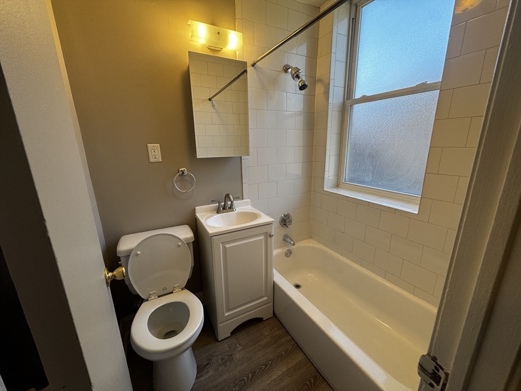 1870 Beacon Street, Unit 54 Brookline, MA 02445 - Photo 9 of 13 a bathroom with a granite countertop sink toilet and shower
