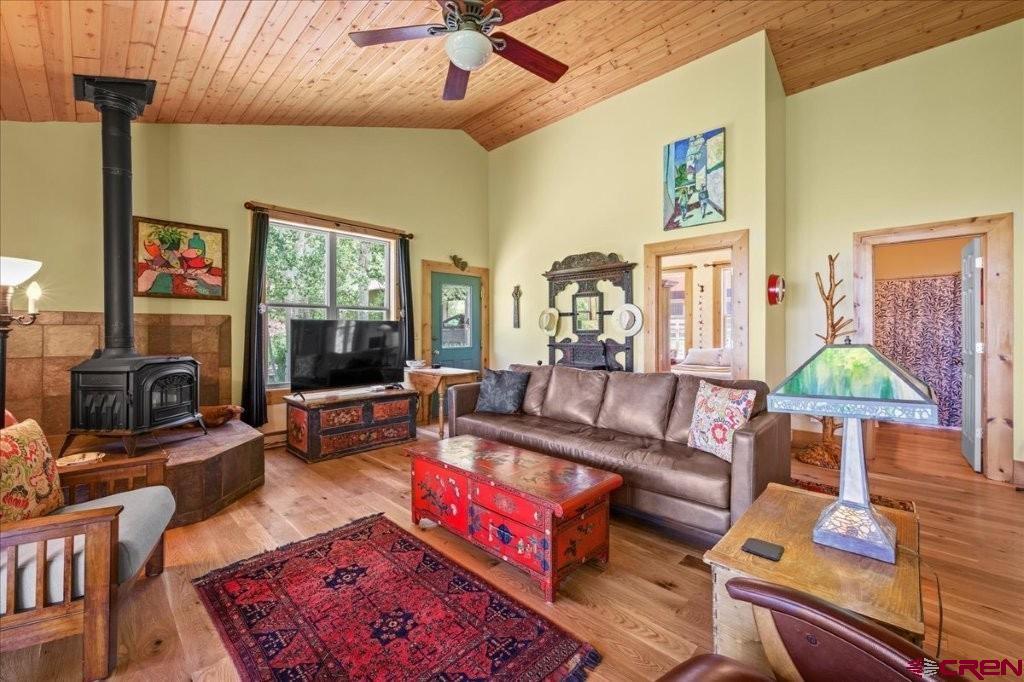 444 Which Way Ridgway, CO 81432 - Photo 11 of 36 a living room with furniture a flat screen tv and a fireplace