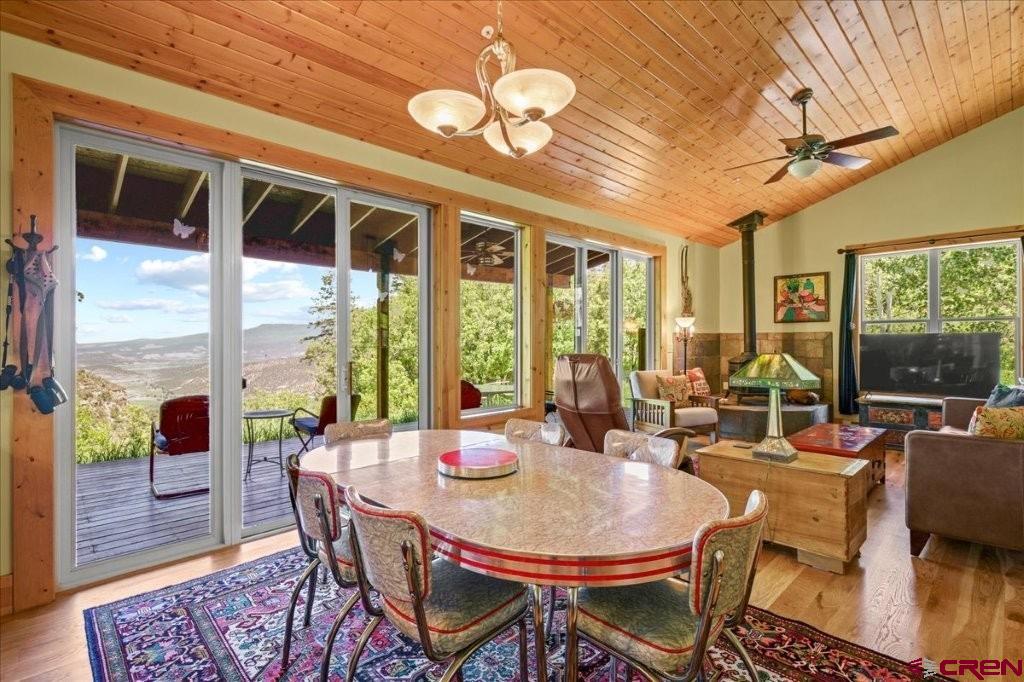 444 Which Way Ridgway, CO 81432 - Photo 12 of 36 a view of a dining room with furniture large windows and wooden floor